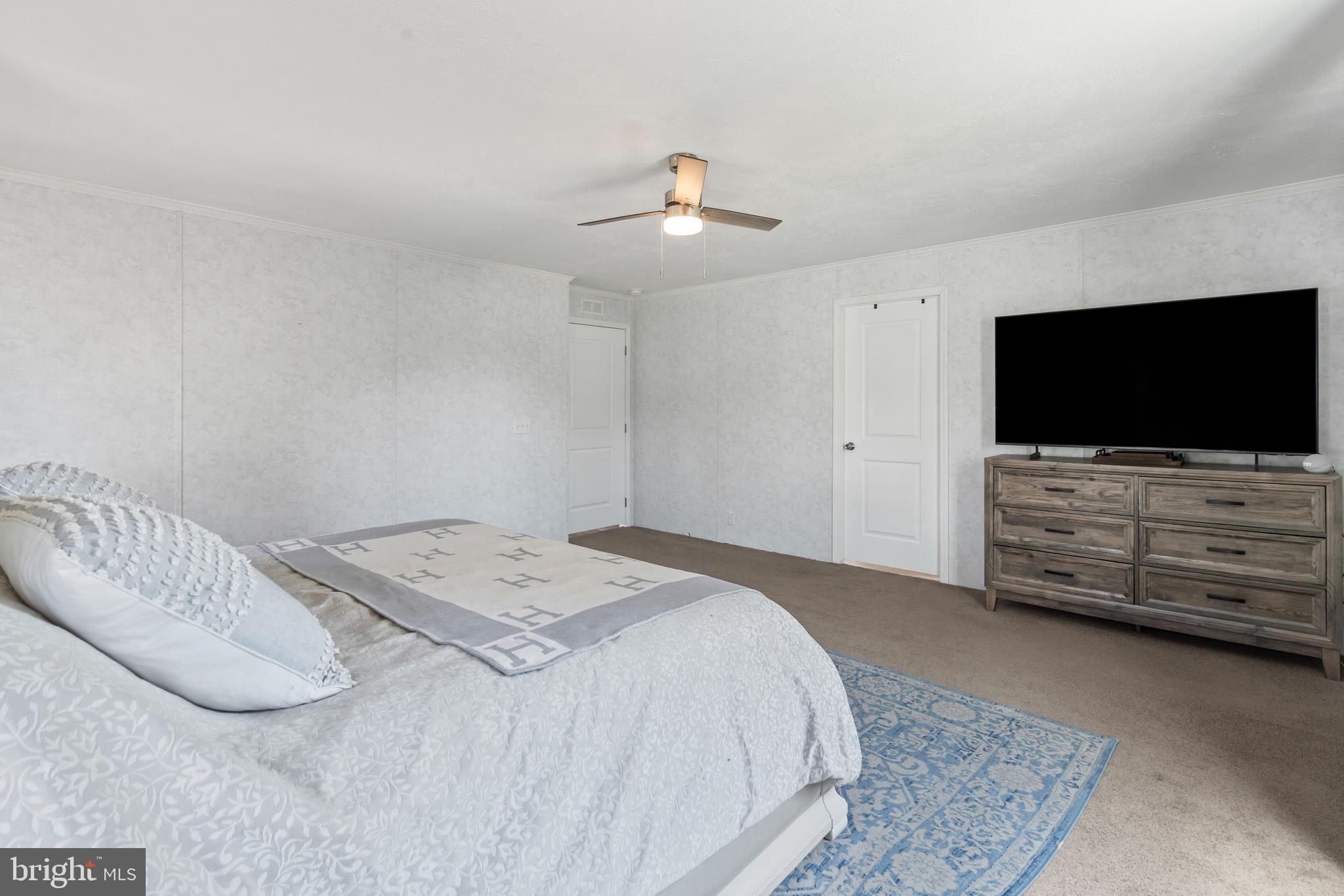 6 Southwind Circle Jackson, NJ 08527 - Photo 23 of 34 a bedroom with a bed and a flat screen tv