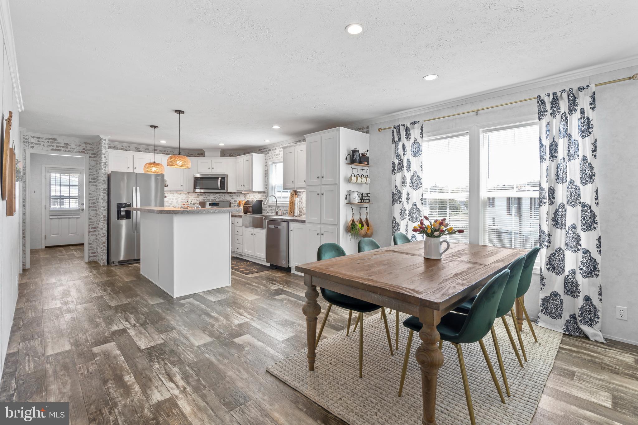 6 Southwind Circle Jackson, NJ 08527 - Photo 5 of 34 a kitchen with stainless steel appliances granite countertop a table chairs and a refrigerator