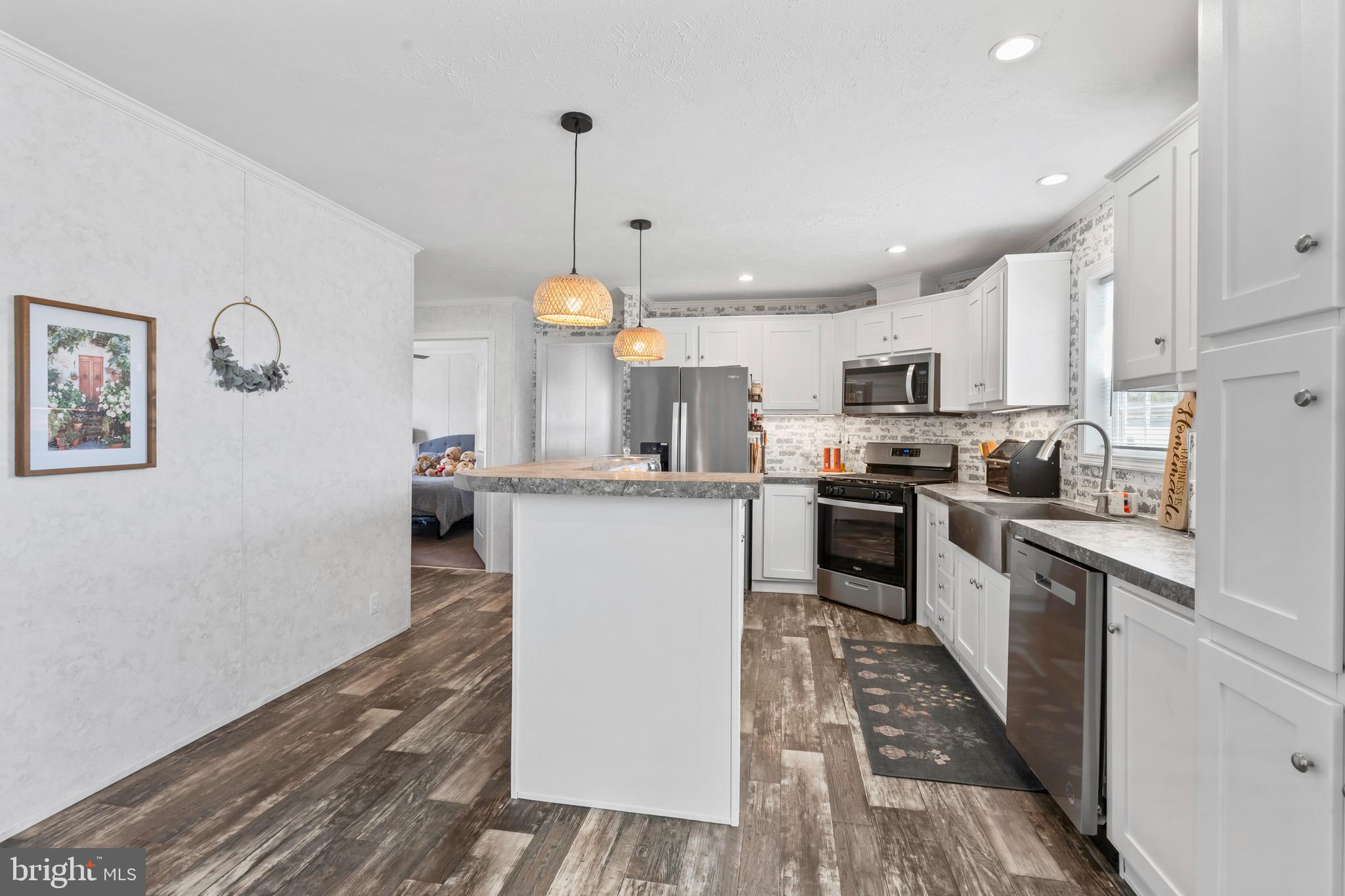 6 Southwind Circle Jackson, NJ 08527 - Photo 6 of 34 a kitchen with stainless steel appliances granite countertop a refrigerator a sink dishwasher a stove and white cabinets with wooden floor