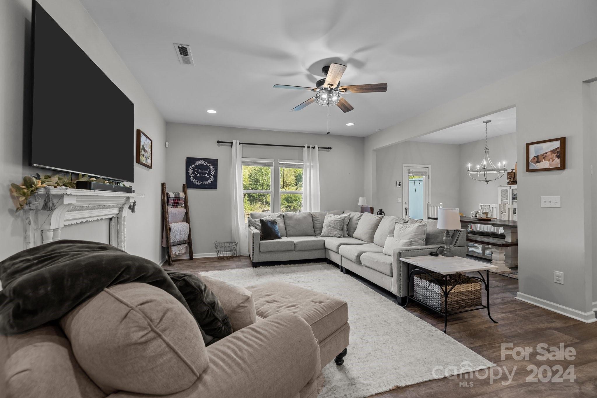 1152 Streamside Lane York, SC 29745 - Photo 12 of 47 a living room with furniture a flat screen tv and a fireplace