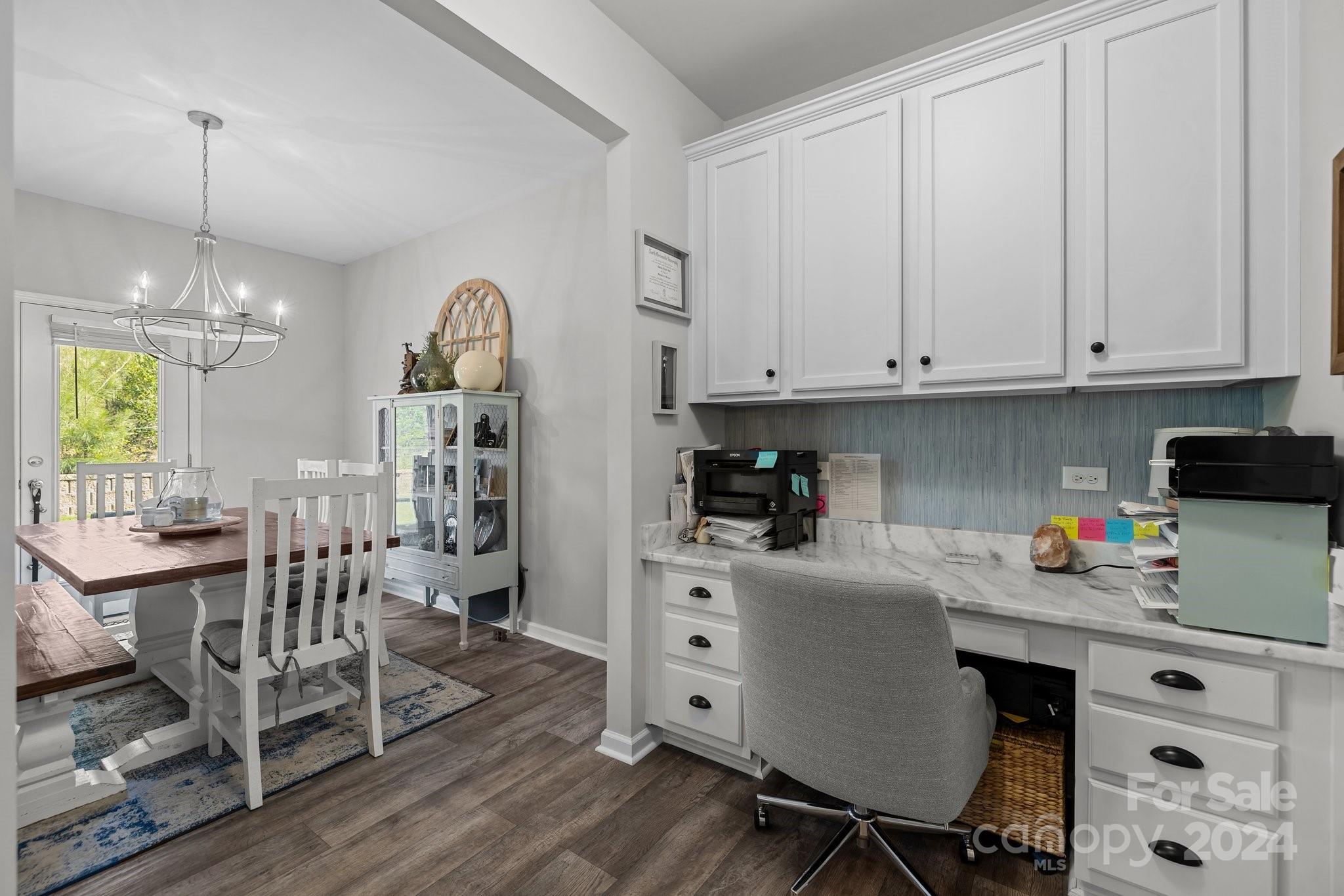 1152 Streamside Lane York, SC 29745 - Photo 15 of 47 a kitchen with stainless steel appliances a white table chairs and a wooden floor