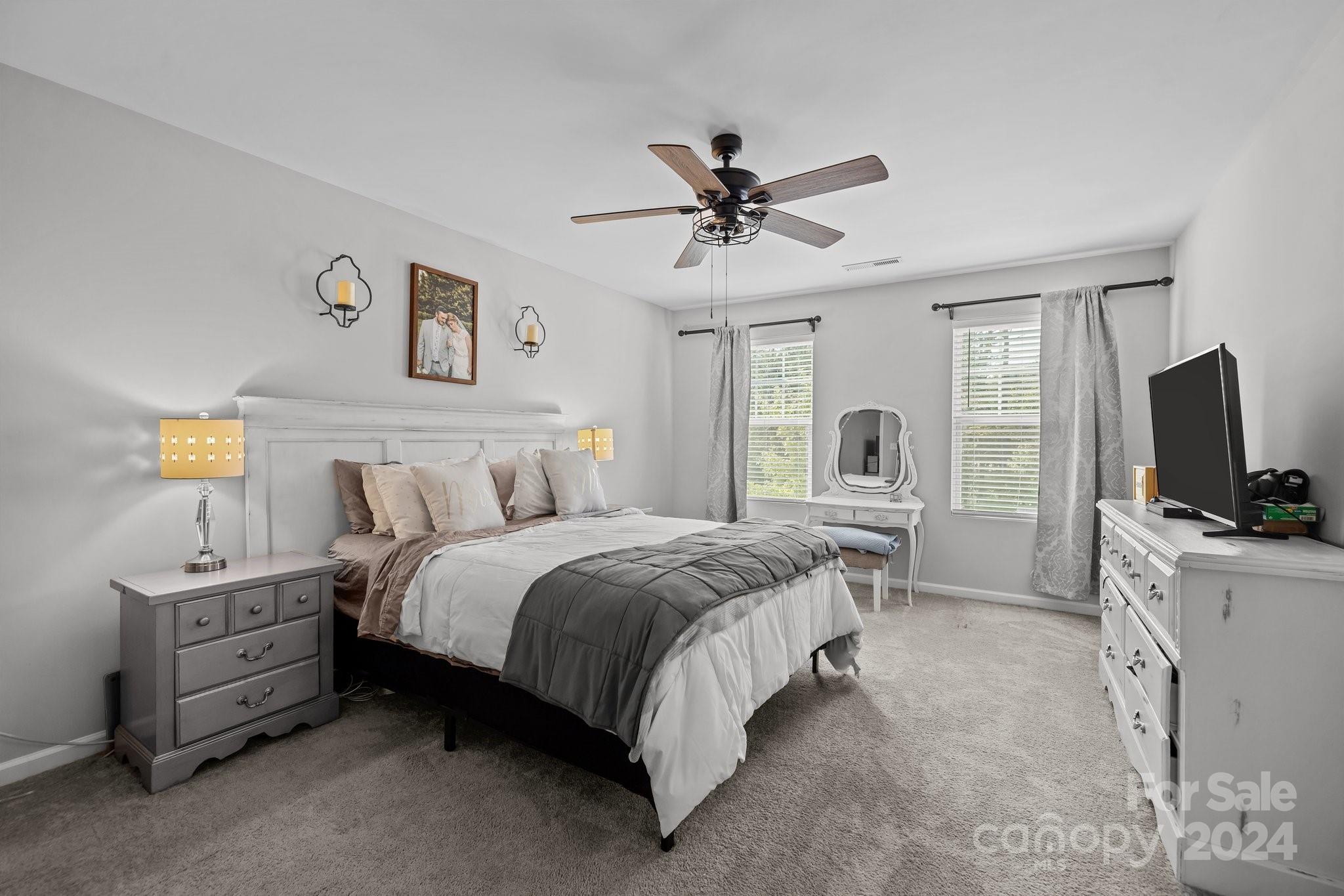 1152 Streamside Lane York, SC 29745 - Photo 26 of 47 a spacious bedroom with a bed and a flat screen tv