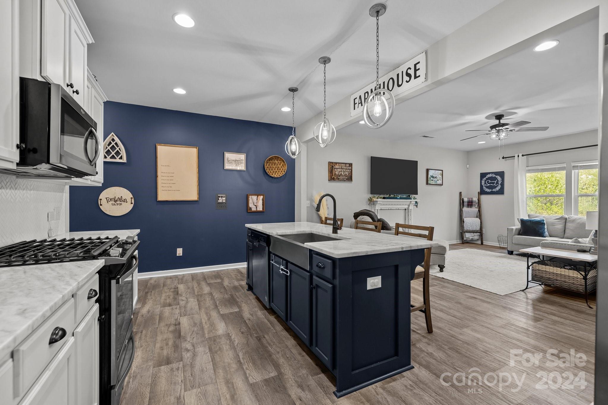 1152 Streamside Lane York, SC 29745 - Photo 6 of 47 a kitchen with a stove and a wooden floor