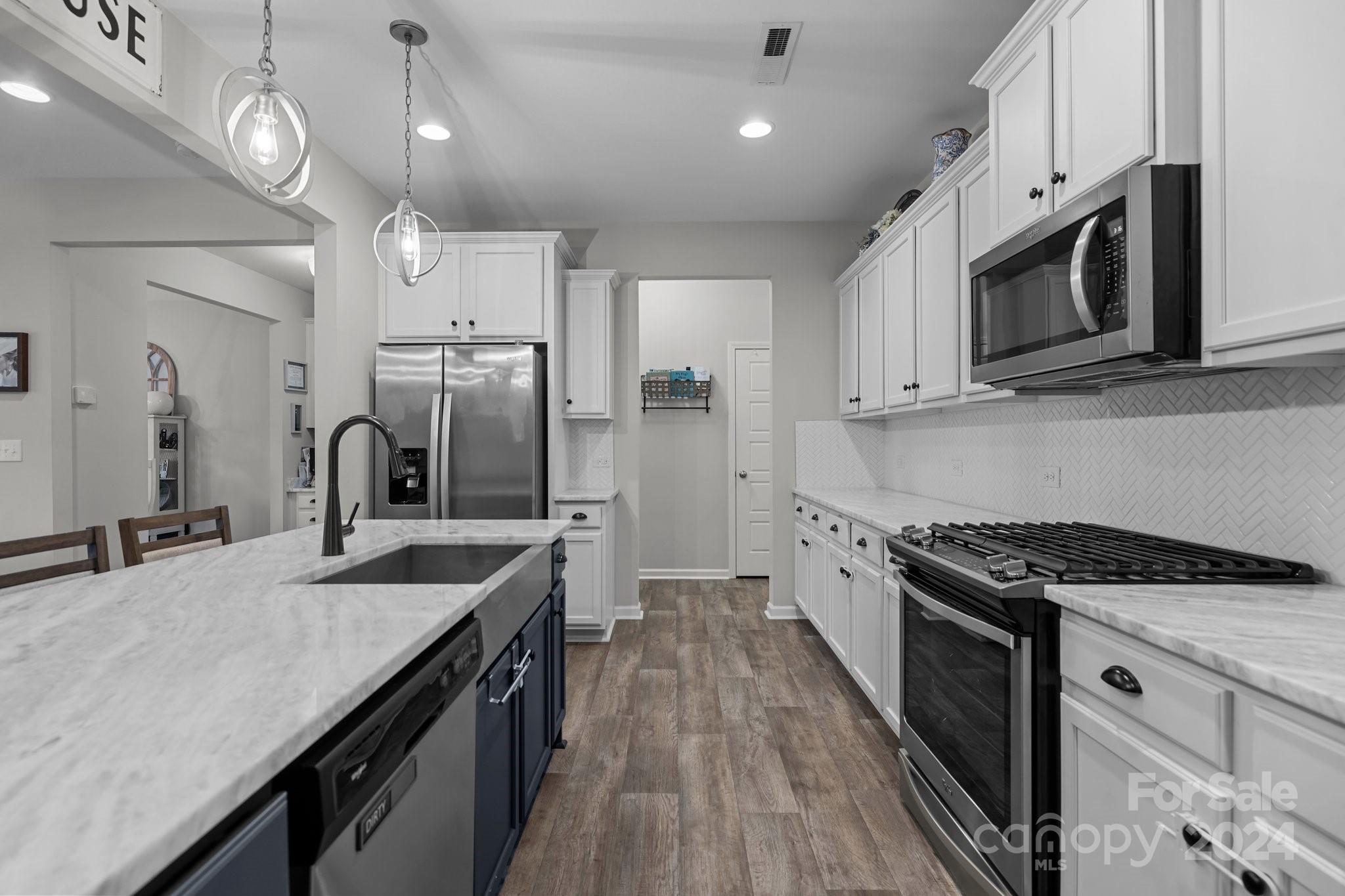 1152 Streamside Lane York, SC 29745 - Photo 9 of 47 a kitchen with stainless steel appliances granite countertop a sink stove microwave and cabinets
