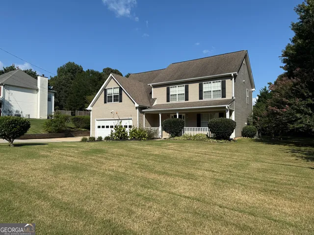 a front view of a house with a garden