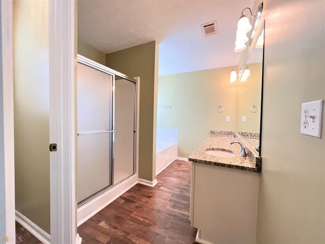 a bedroom with a bed and a chandelier fan