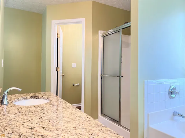 a bathroom with a bathtub and shower