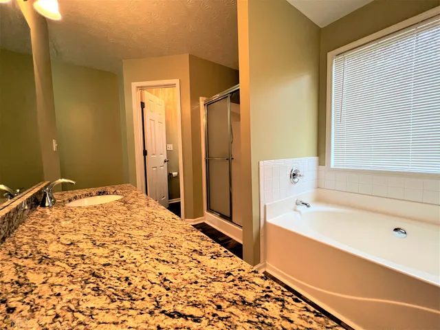 a bathroom with a bathtub and a shower