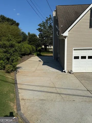 a white house with tree in front of it