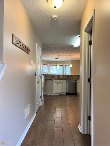 a view of a kitchen with a refrigerator and a sink