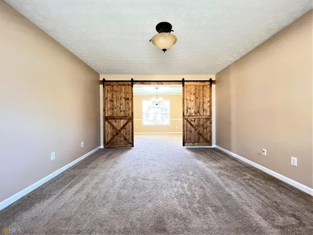 an empty room with windows and closet