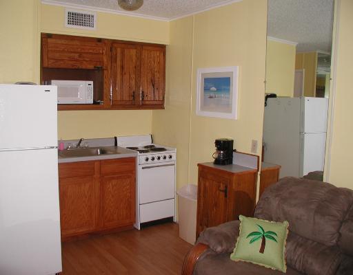 3938 Surfside, Unit 2307 Corpus Christi, TX 78402 - Photo 2 of 4 a bedroom with a bed and a dresser