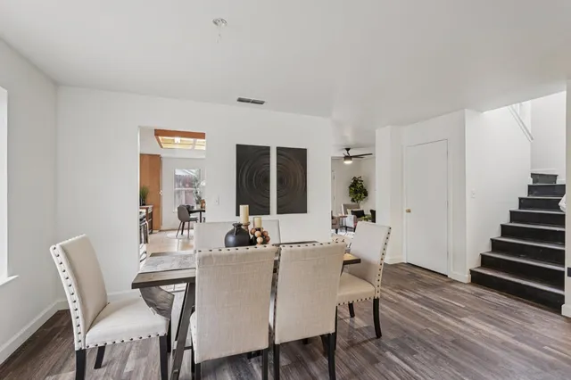 a view of a dining room with furniture window and wooden floor