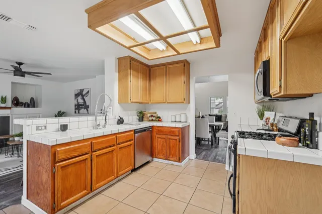a kitchen with stainless steel appliances granite countertop a sink and cabinets