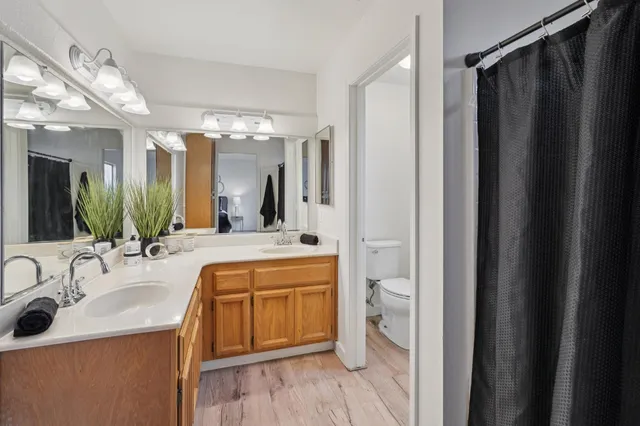 a bathroom with a double vanity sink and mirror