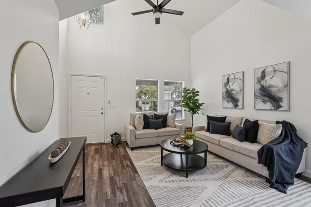 a living room with furniture and a wooden floor