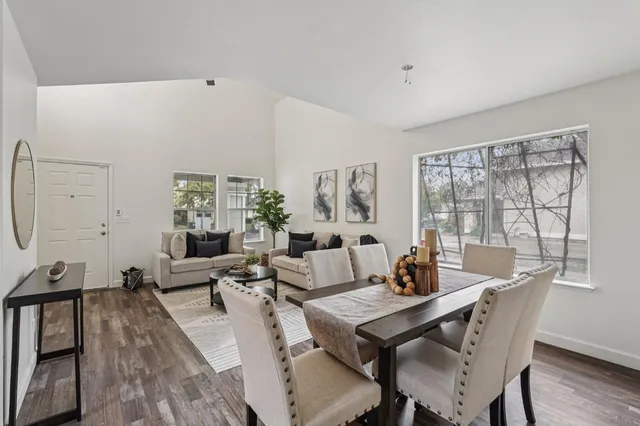 a view of a dining room with furniture window and wooden floor