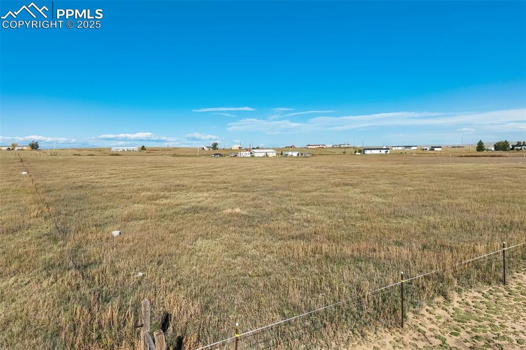 6325 Night Train Lane Yoder, CO 80864 - Photo 17 of 20 View of grassy yard featuring a view of countryside