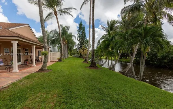 a view of a house with a yard and a patio