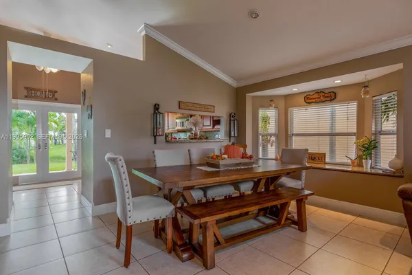 a view of a dining room with furniture and a large window