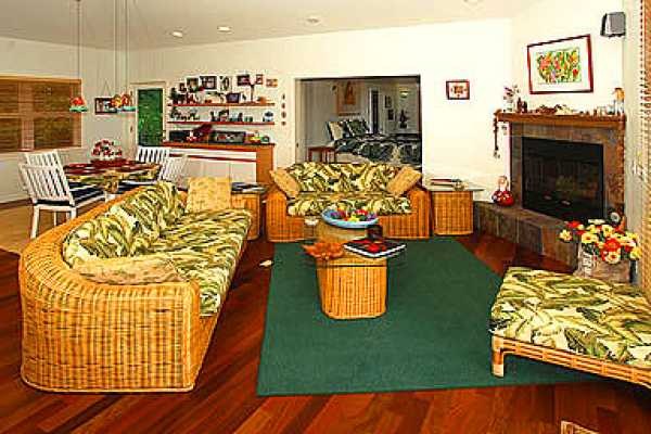 2211 D Pane Road Koloa, HI 96756 - Photo 2 of 12 a living room with furniture floor to ceiling window and a fireplace