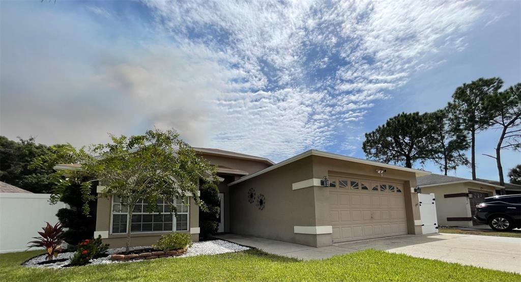 7934 Hathaway Drive New Port Richey, FL 34654 - Photo 1 of 47 a view of a house with a yard and a fountain