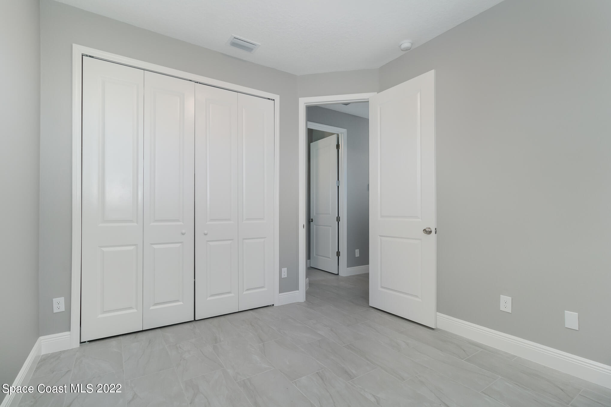 295 San Marino Road Southwest Palm Bay, FL 32908 - Photo 11 of 49 a view of an empty room and closet area