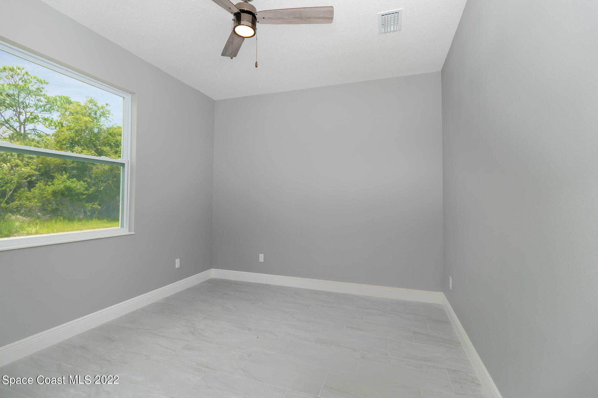 295 San Marino Road Southwest Palm Bay, FL 32908 - Photo 22 of 49 an empty room with a window