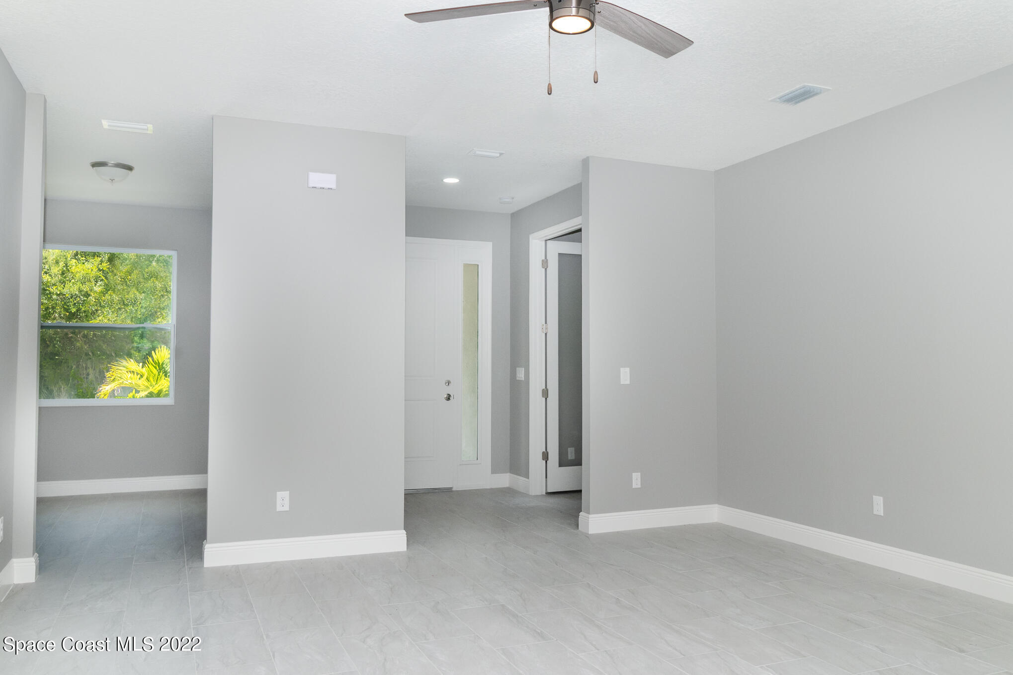 295 San Marino Road Southwest Palm Bay, FL 32908 - Photo 24 of 49 an empty room with windows and closet