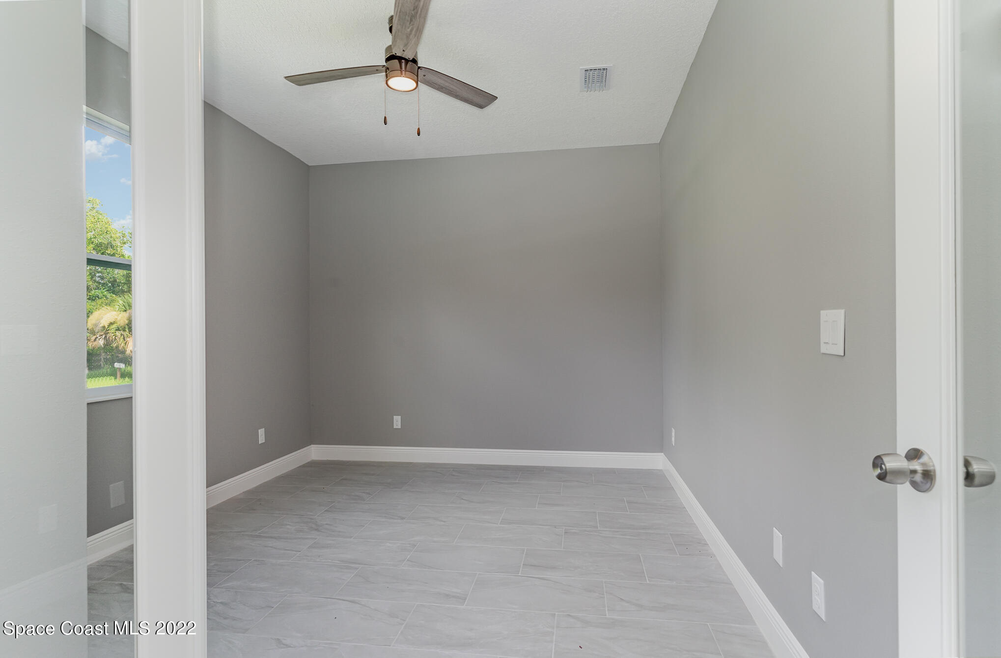 295 San Marino Road Southwest Palm Bay, FL 32908 - Photo 25 of 49 wooden floor in an empty room with a window