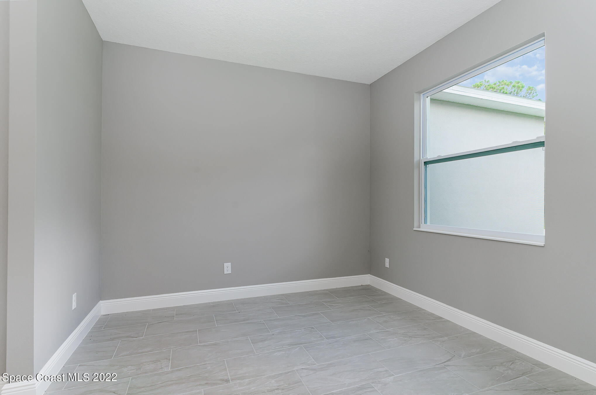 295 San Marino Road Southwest Palm Bay, FL 32908 - Photo 27 of 49 an empty room with a window