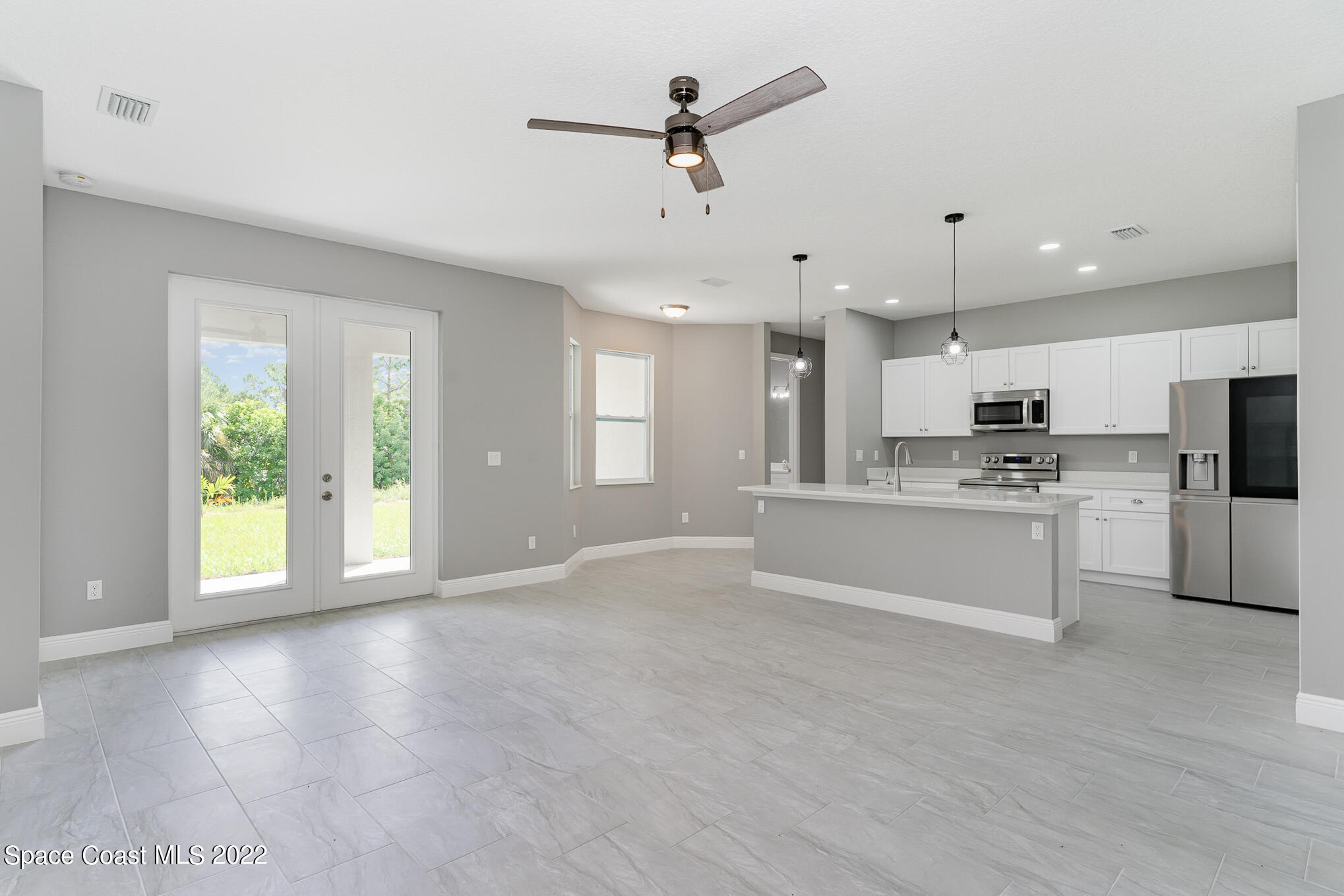 295 San Marino Road Southwest Palm Bay, FL 32908 - Photo 34 of 49 a view of an empty room with kitchen appliances and a window
