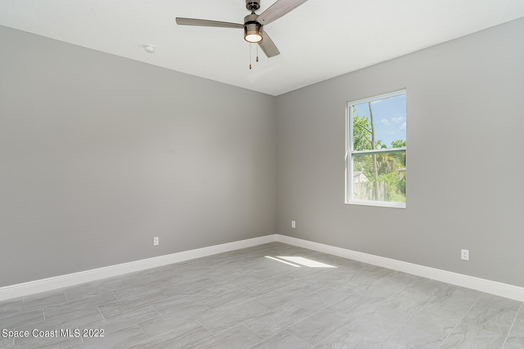 295 San Marino Road Southwest Palm Bay, FL 32908 - Photo 36 of 49 an empty room with a window