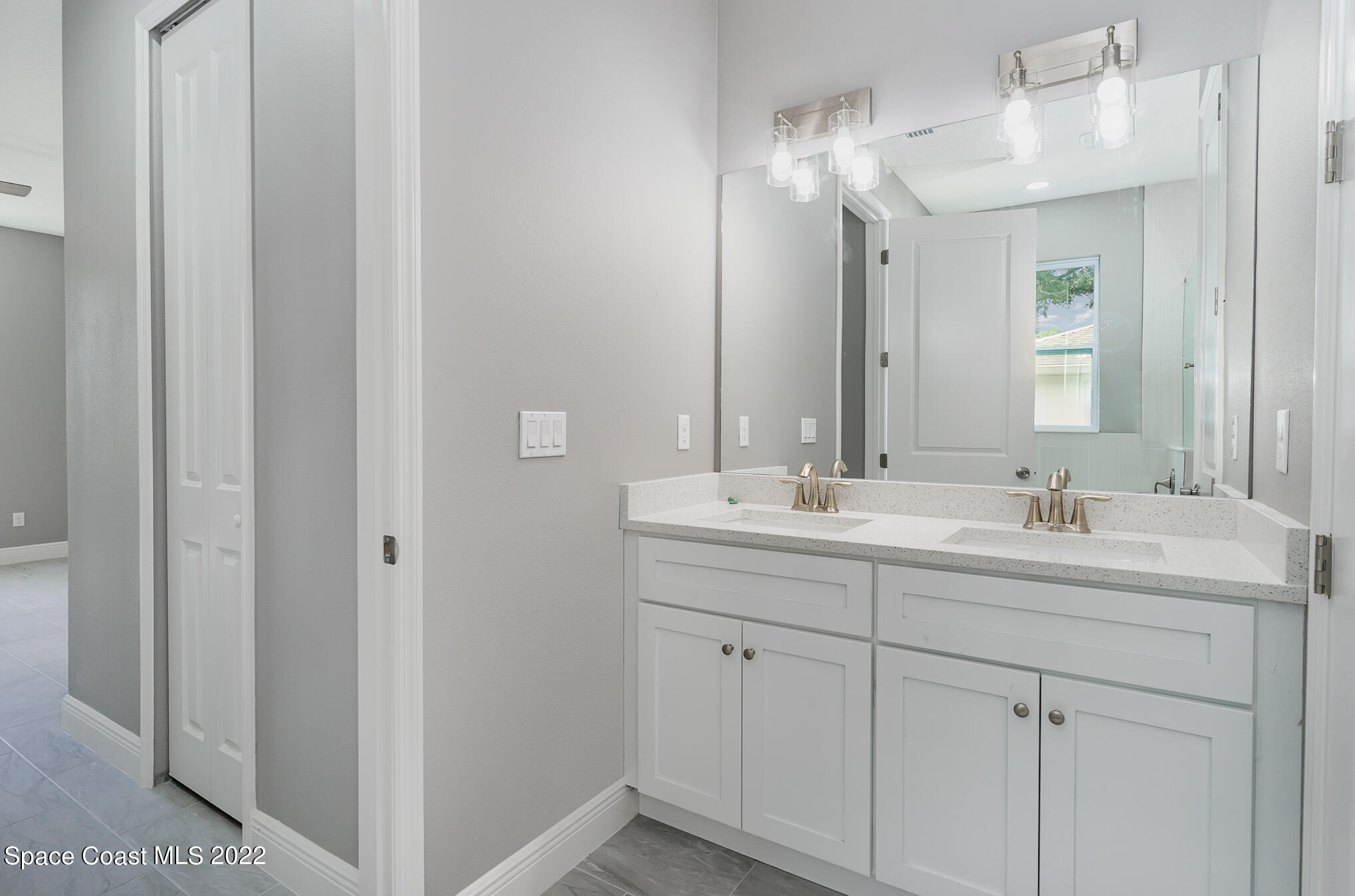 295 San Marino Road Southwest Palm Bay, FL 32908 - Photo 39 of 49 a bathroom with 2 sink and a mirror