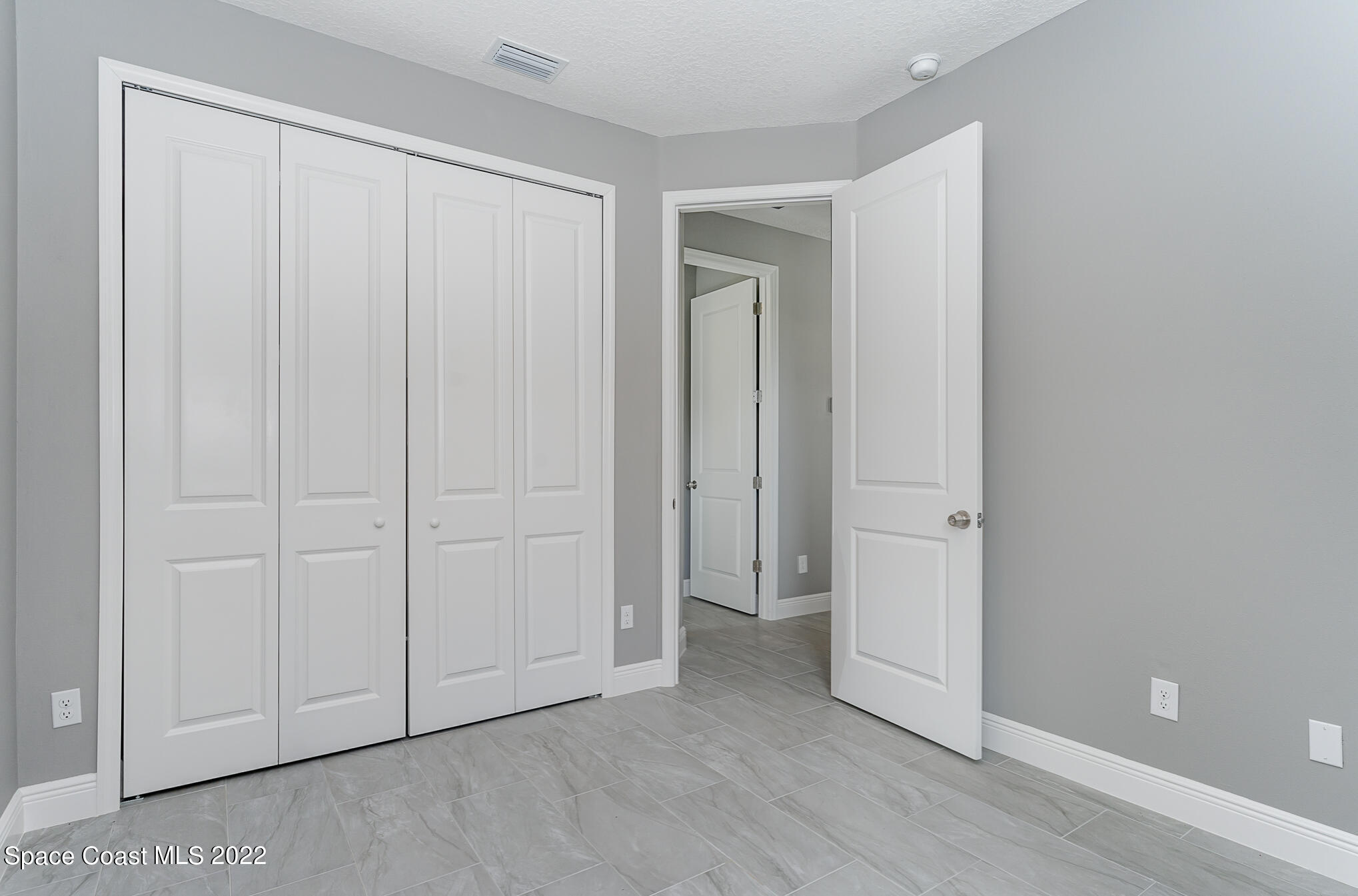 295 San Marino Road Southwest Palm Bay, FL 32908 - Photo 44 of 49 a view of an empty room and wooden floor