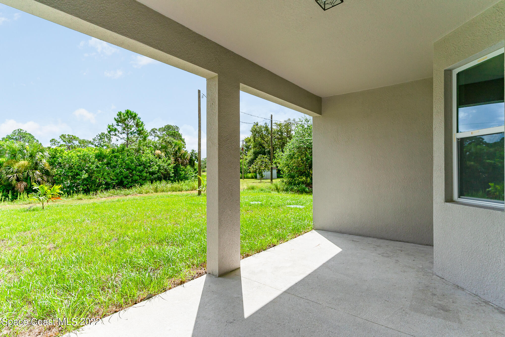 295 San Marino Road Southwest Palm Bay, FL 32908 - Photo 45 of 49 a porch with a yard