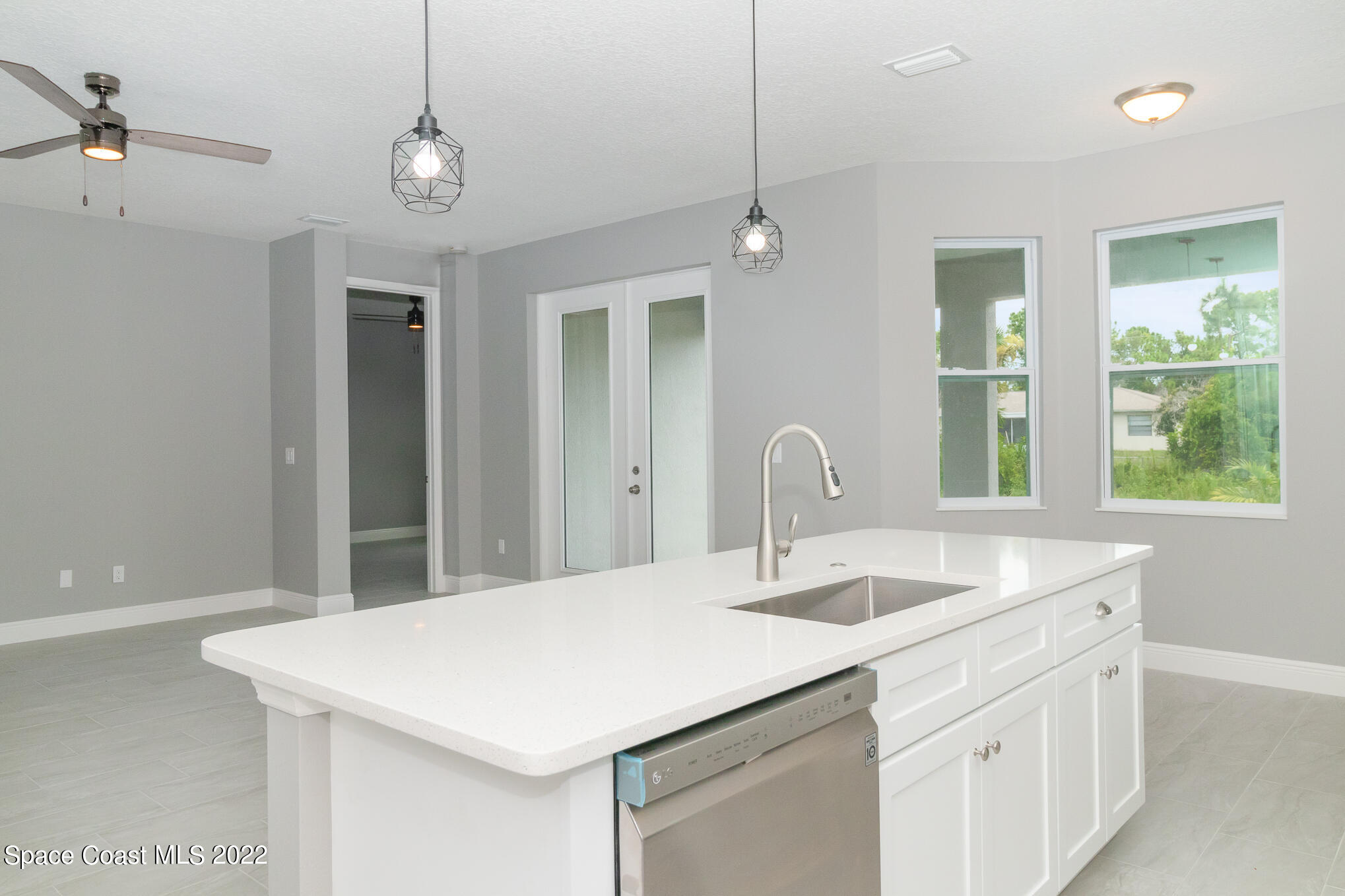 295 San Marino Road Southwest Palm Bay, FL 32908 - Photo 6 of 49 a kitchen with a sink and a window