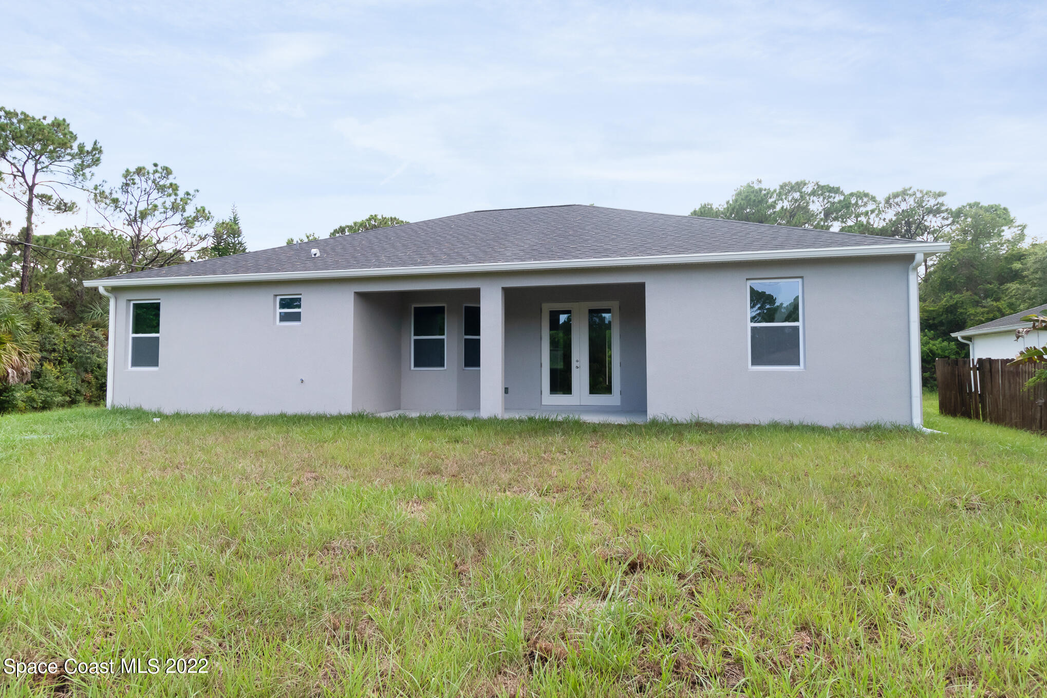 295 San Marino Road Southwest Palm Bay, FL 32908 - Photo 10 of 49 a backyard of a house with lots of green space