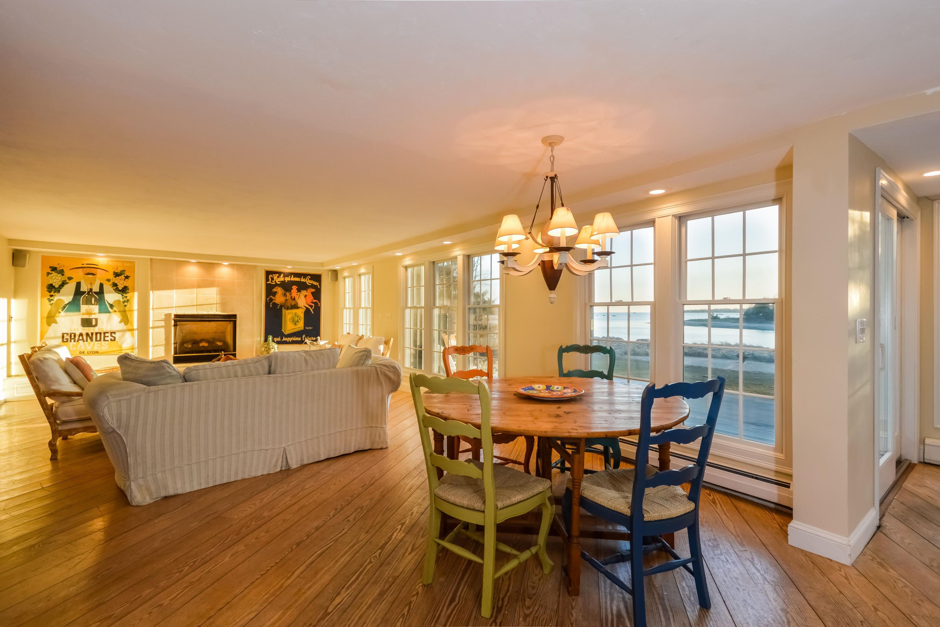 310 Shore Road Bourne, MA 02532 - Photo 11 of 31 a dining room with furniture a chandelier and wooden floor