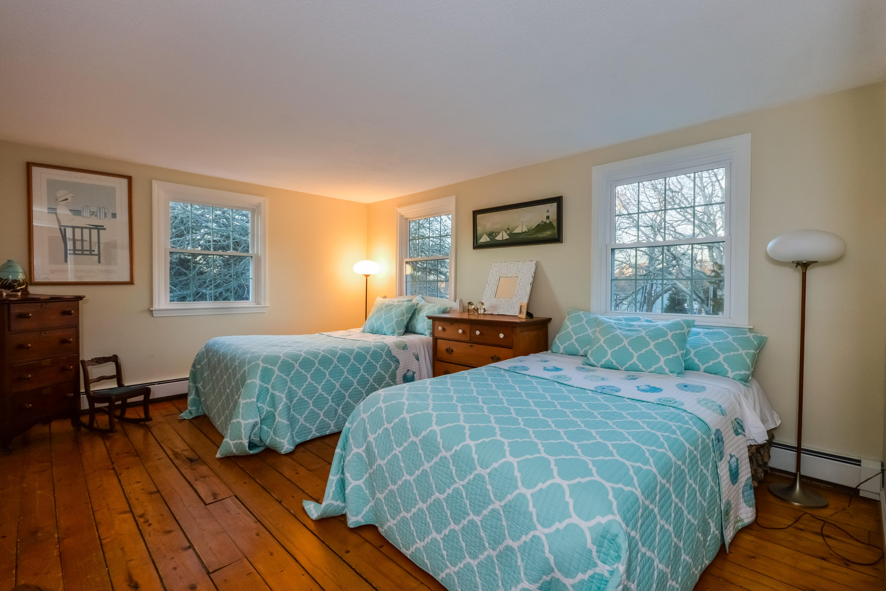 310 Shore Road Bourne, MA 02532 - Photo 23 of 31 a bedroom with two beds and a dresser next to a window
