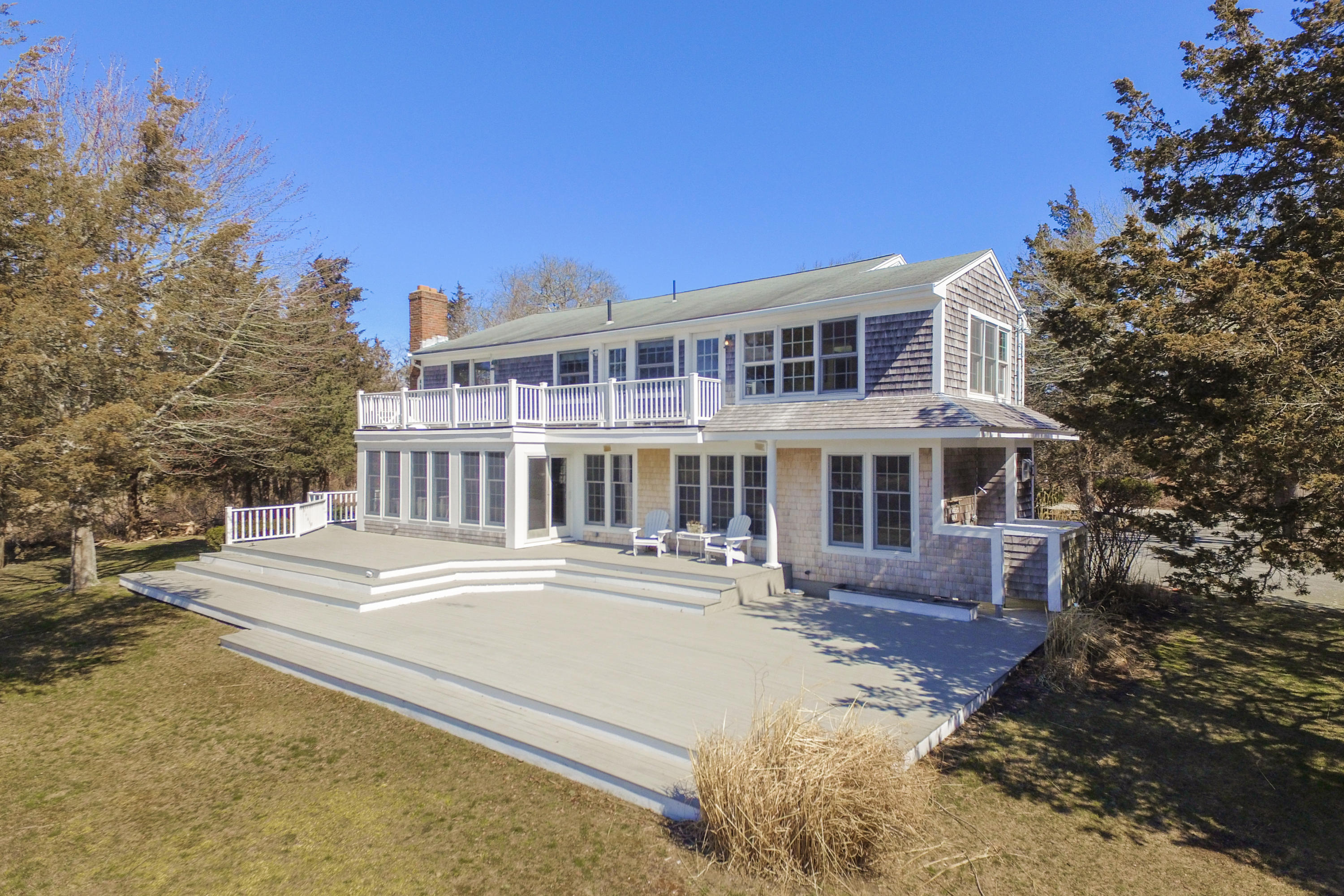 310 Shore Road Bourne, MA 02532 - Photo 5 of 31 a front view of a house with a yard
