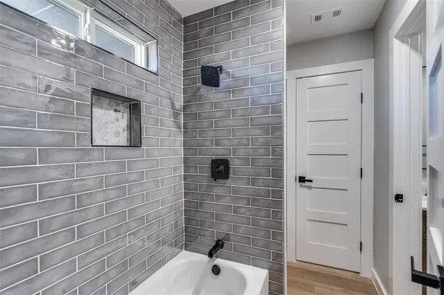 a bathroom with a shower and a sink
