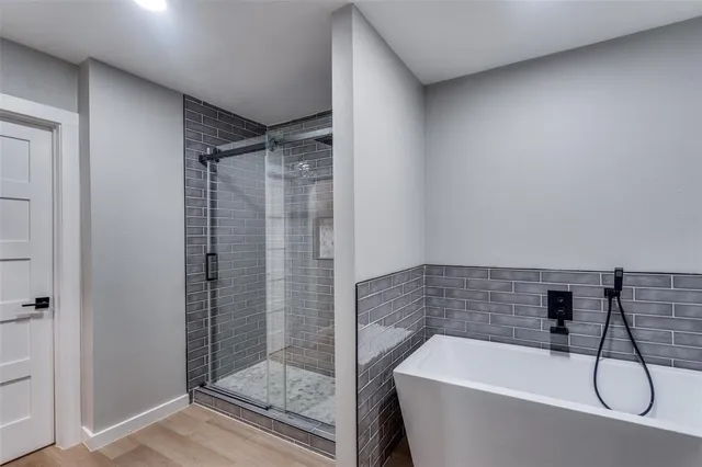 a bathroom with a bath tub and shower