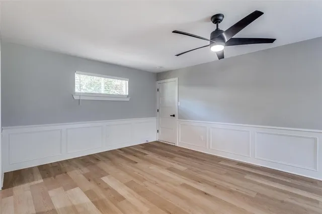 wooden floor in an empty room with a window