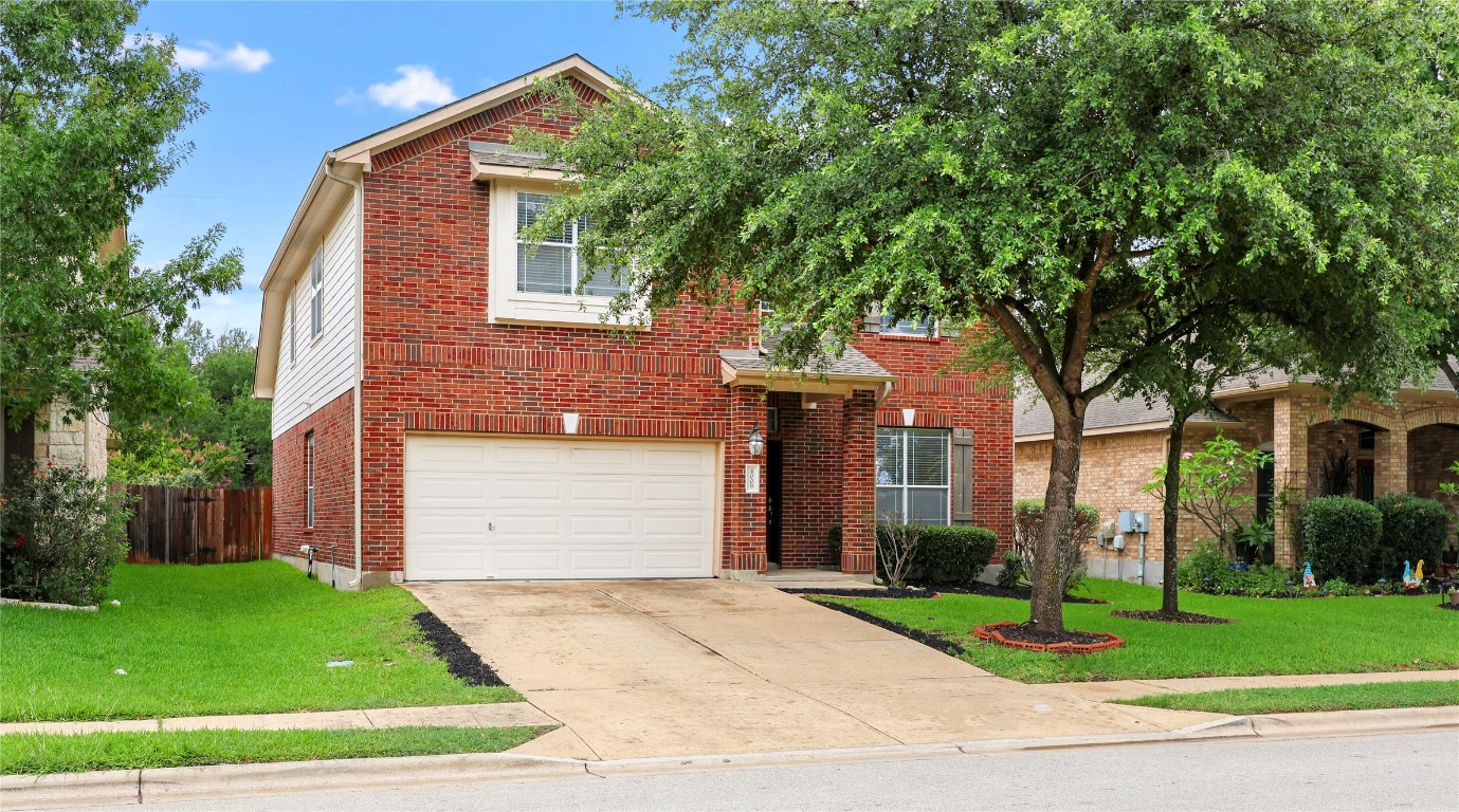a front view of house with a garden