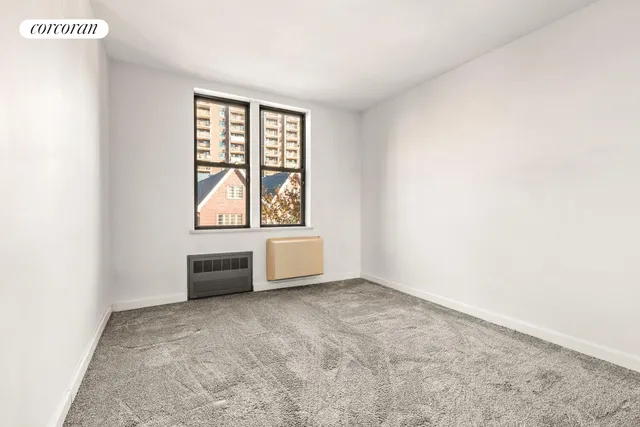 a bedroom with furniture and a large window