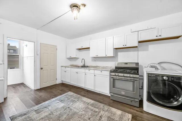 a kitchen with a stove top oven and cabinets