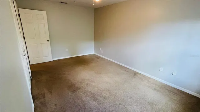 an empty room with a ceiling fan