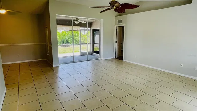 a view of hallway with a large window and chandelier