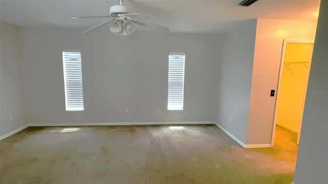 a view of room with window and ceiling fan